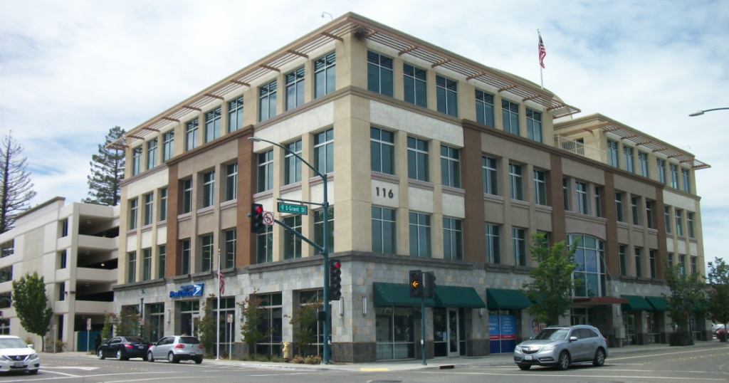 Building located on corner of a busy street.