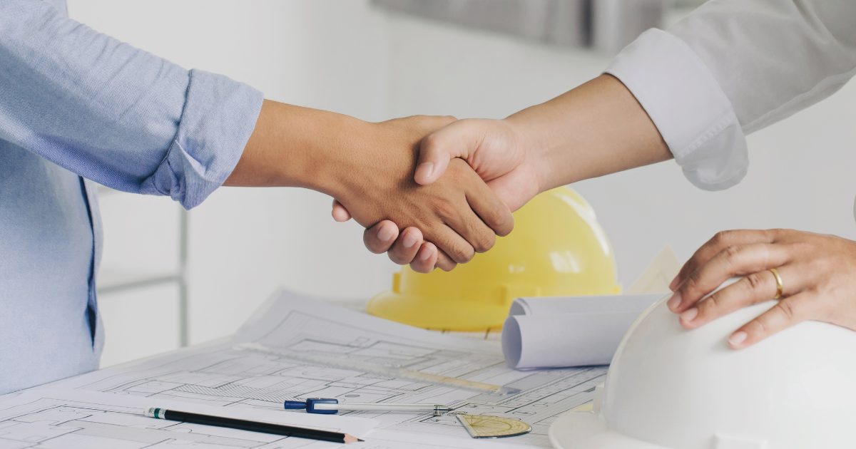 Two people shaking hands, signifying project development expert witness services