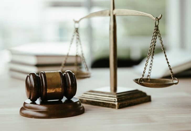 An image of a magnifying glass over the legal and regulatory aspects of surveying.